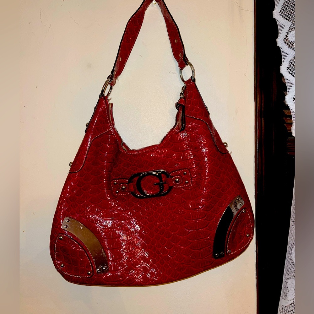Vintage Guess large shiny hobo handbag with silver accents. Deep red.
